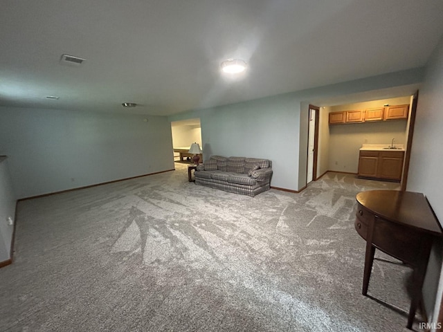 living room with light carpet and sink