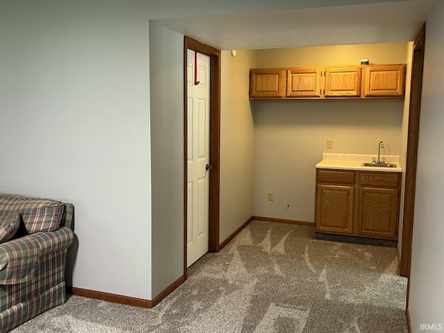 kitchen with dark colored carpet and sink