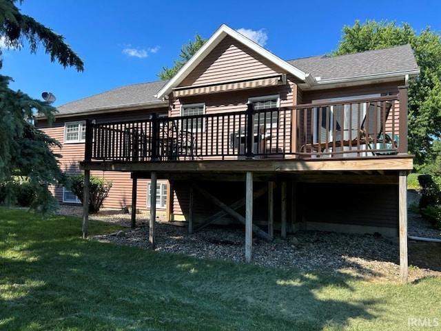 rear view of property featuring a lawn and a wooden deck