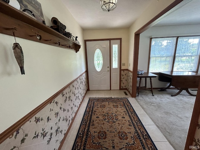 foyer with light colored carpet and plenty of natural light