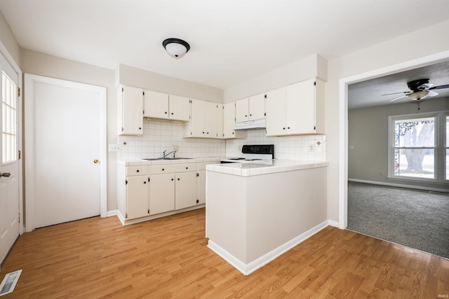 kitchen with tile countertops, white cabinets, sink, light hardwood / wood-style flooring, and black electric range