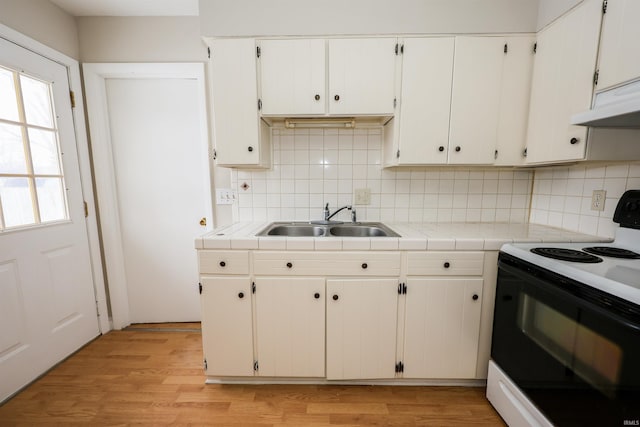 kitchen with tasteful backsplash, sink, tile countertops, white electric range, and white cabinetry