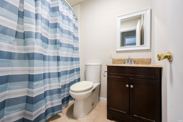 bathroom with tile patterned flooring, vanity, toilet, and walk in shower