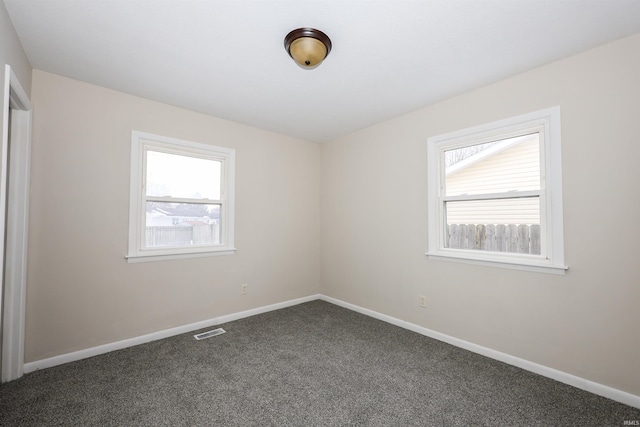 empty room with dark colored carpet