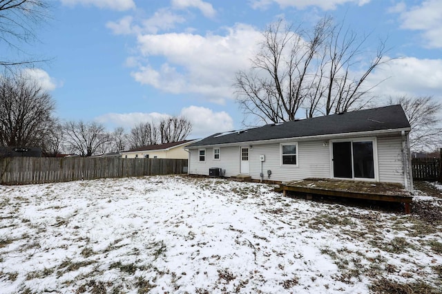 snow covered property featuring central AC and a deck