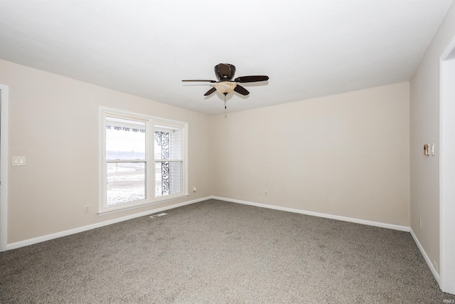 empty room featuring ceiling fan and carpet floors