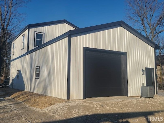 view of outbuilding featuring cooling unit and a garage