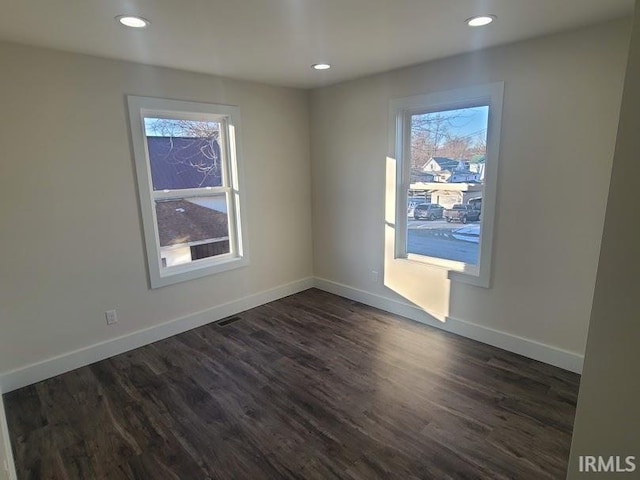 empty room with dark hardwood / wood-style floors