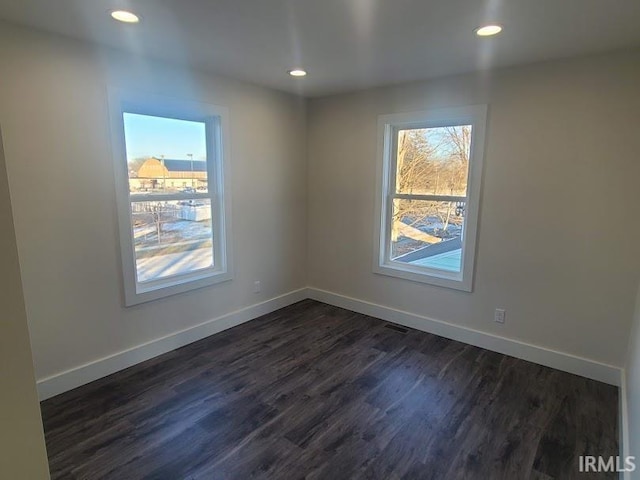 spare room featuring dark hardwood / wood-style floors