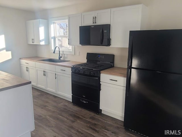 kitchen featuring dark hardwood / wood-style flooring, white cabinetry, sink, and black appliances