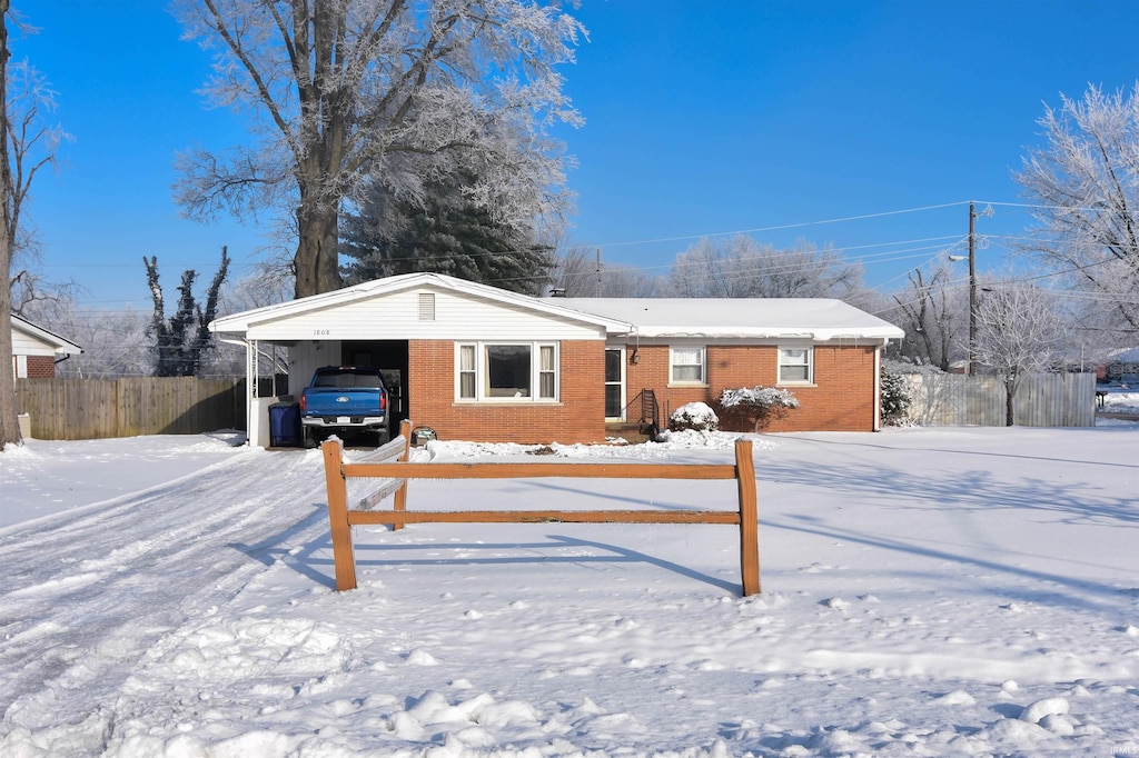 ranch-style house featuring a carport