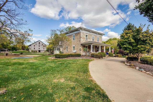 view of front facade with a front lawn and a porch