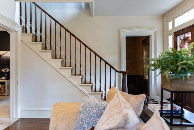 entrance foyer with crown molding and dark wood-type flooring