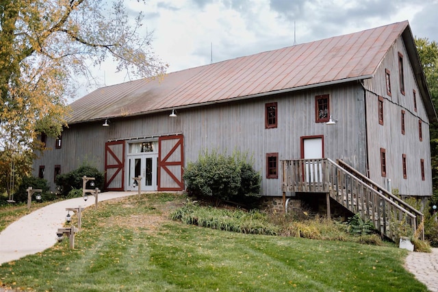 rear view of house with an outbuilding and a yard