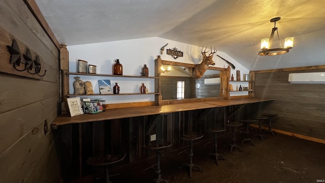 bar with pendant lighting, lofted ceiling, wooden walls, and an AC wall unit