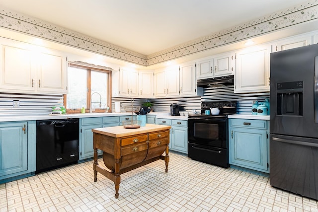 kitchen with backsplash, black appliances, white cabinets, sink, and blue cabinetry