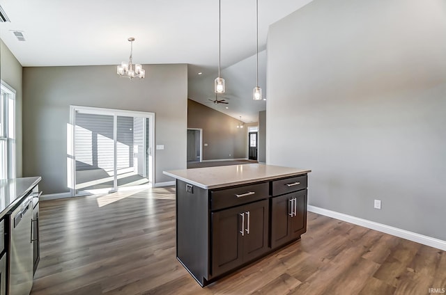 kitchen with ceiling fan with notable chandelier, dark brown cabinetry, decorative light fixtures, a kitchen island, and lofted ceiling