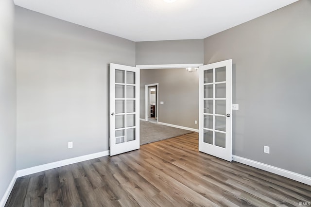 empty room with french doors and hardwood / wood-style flooring