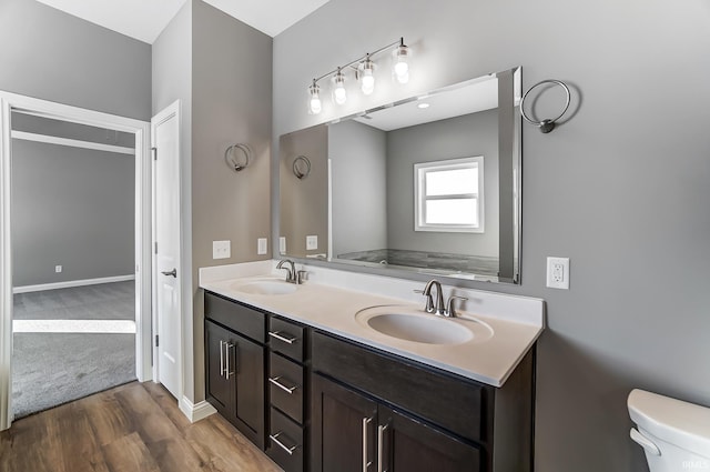 bathroom with vanity, wood-type flooring, and toilet