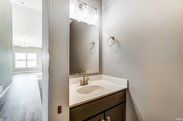 bathroom with vanity and an inviting chandelier