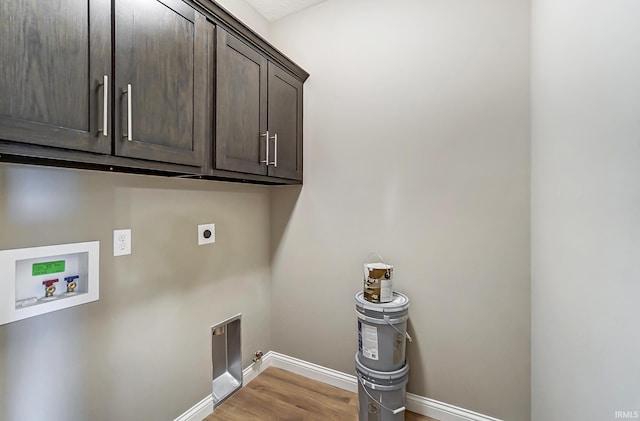 laundry room featuring cabinets, washer hookup, light hardwood / wood-style flooring, and electric dryer hookup