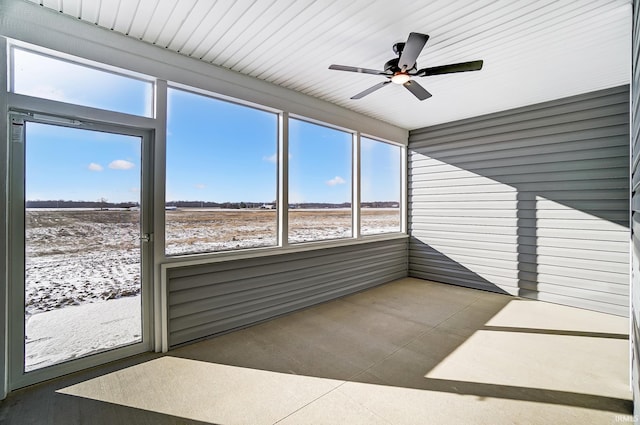 unfurnished sunroom with ceiling fan