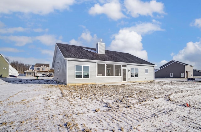 rear view of property with a sunroom