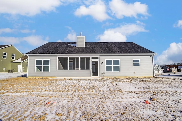 rear view of house with central AC