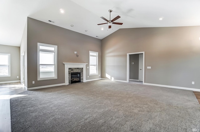 unfurnished living room with ceiling fan, a fireplace, high vaulted ceiling, and dark carpet