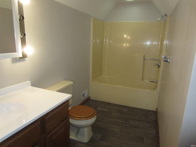 full bathroom featuring shower / bathing tub combination, vanity, vaulted ceiling, toilet, and wood-type flooring