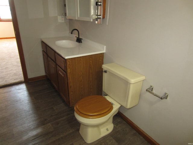 bathroom with vanity, hardwood / wood-style flooring, and toilet