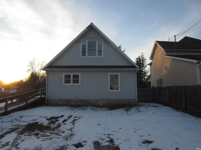 view of snow covered back of property