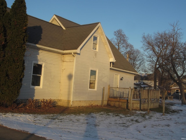 snow covered property with a deck