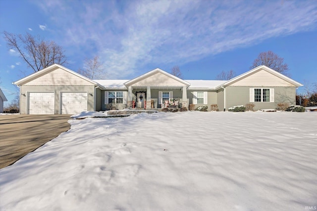 single story home featuring covered porch and a garage