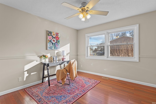 office area featuring hardwood / wood-style floors, a textured ceiling, and ceiling fan