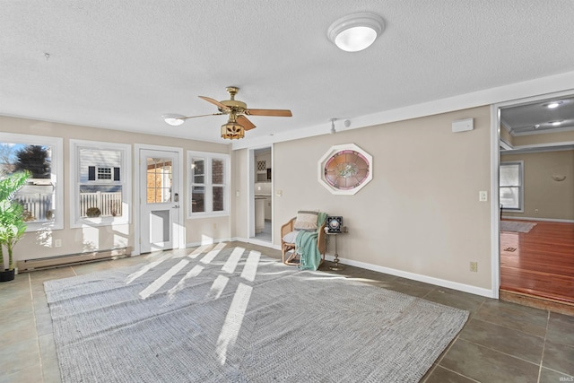 unfurnished bedroom featuring ceiling fan, a textured ceiling, and a baseboard radiator