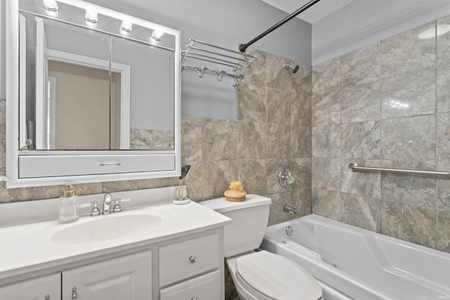 full bathroom featuring vanity, tiled shower / bath combo, and toilet