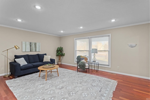 living room with wood-type flooring and ornamental molding