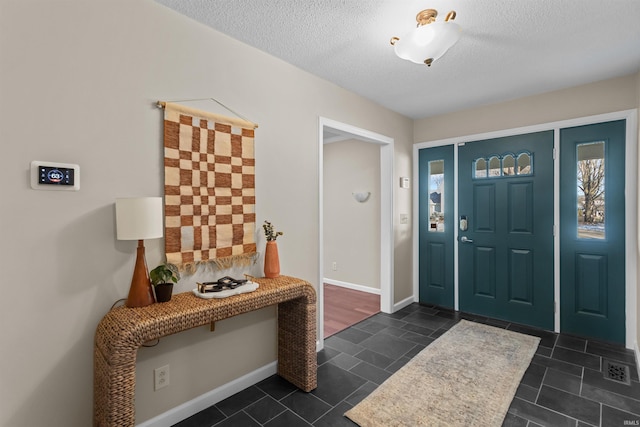 entryway featuring a textured ceiling