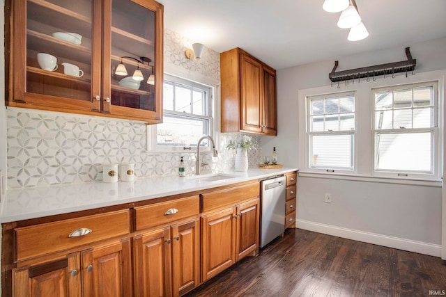 kitchen featuring dishwasher, a healthy amount of sunlight, decorative backsplash, and sink