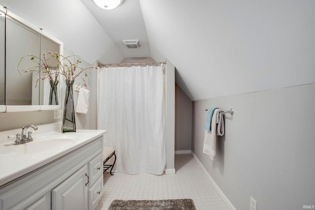 bathroom with a shower with curtain, vanity, and vaulted ceiling