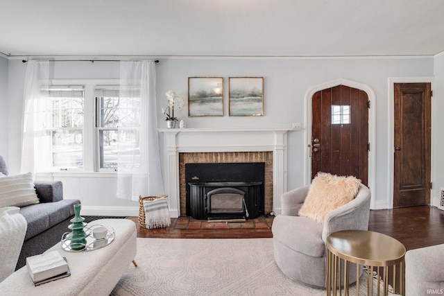 living room with hardwood / wood-style floors and a wood stove