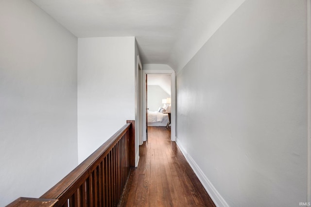 hall with dark hardwood / wood-style flooring and lofted ceiling