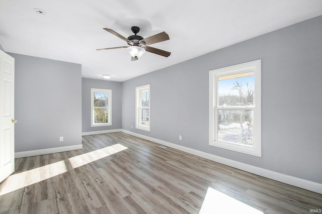 unfurnished room with plenty of natural light, ceiling fan, and light hardwood / wood-style flooring