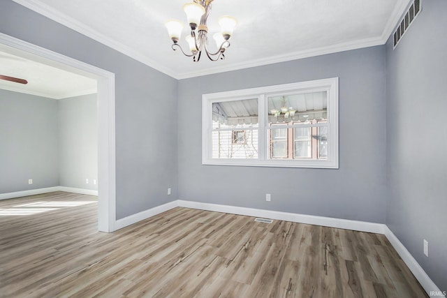 empty room with a notable chandelier, ornamental molding, and light hardwood / wood-style flooring