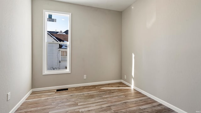 spare room featuring light wood-type flooring