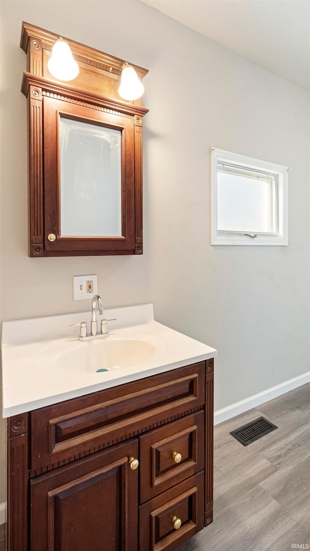 bathroom featuring vanity and hardwood / wood-style flooring