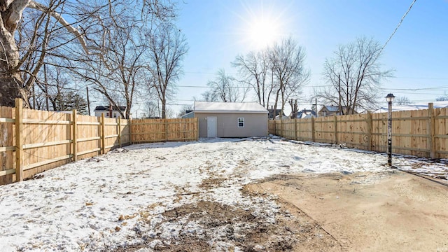 yard covered in snow featuring an outbuilding