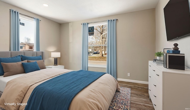 bedroom with dark hardwood / wood-style floors