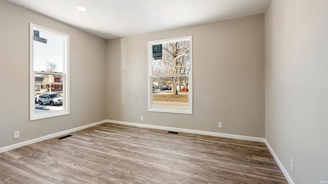 empty room with light hardwood / wood-style flooring